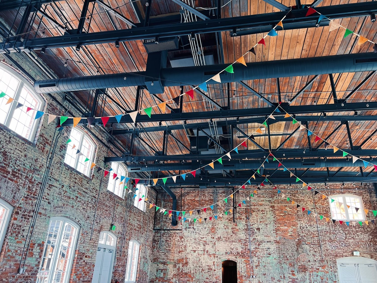 a brick building with flags from the ceiling