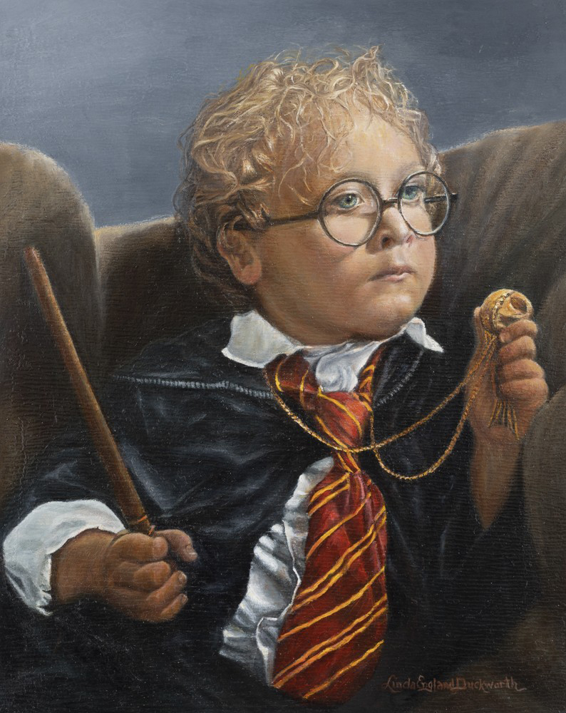 a child in a garment holding a wand