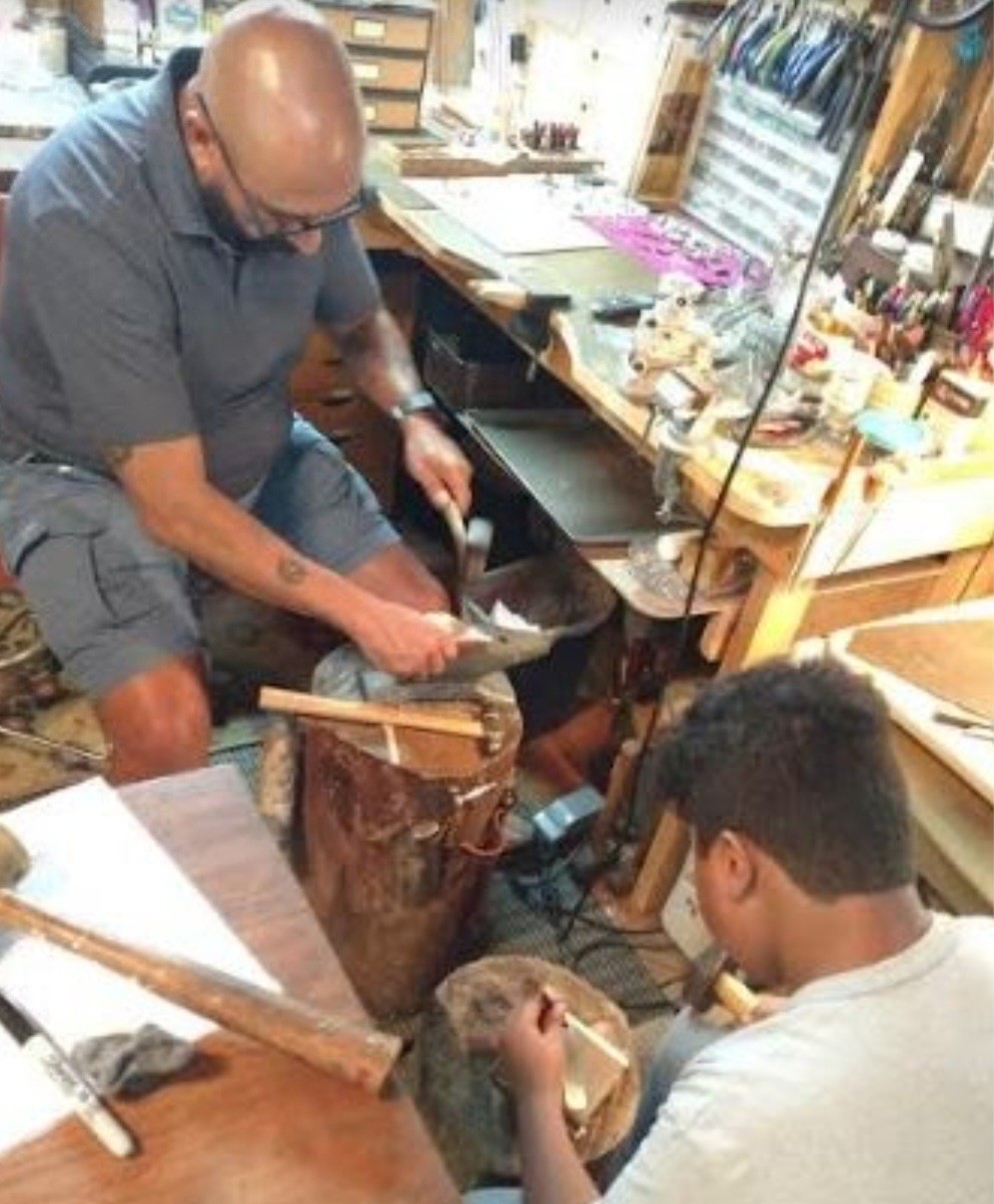 a man working on a piece of wood
