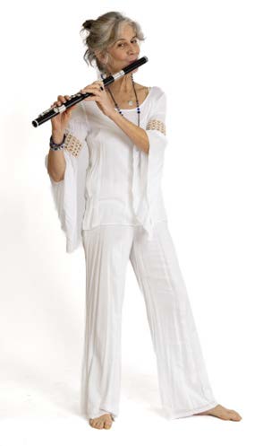 a woman in white holding a flute
