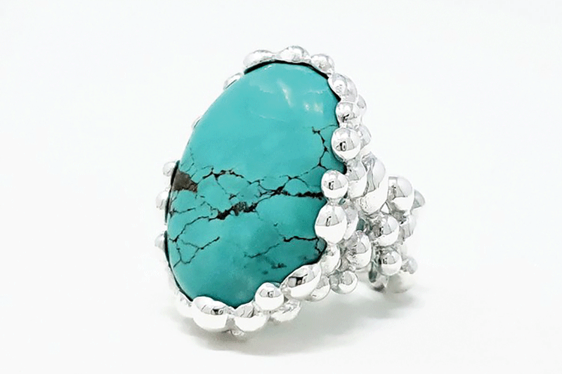 a blue stone ring with silver beads