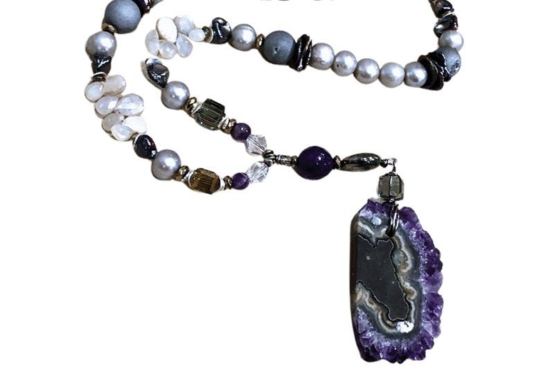 a necklace with a purple and white stone pendant