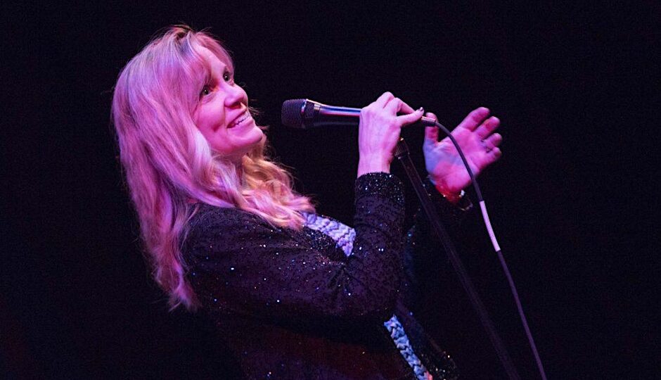 a woman singing into a microphone