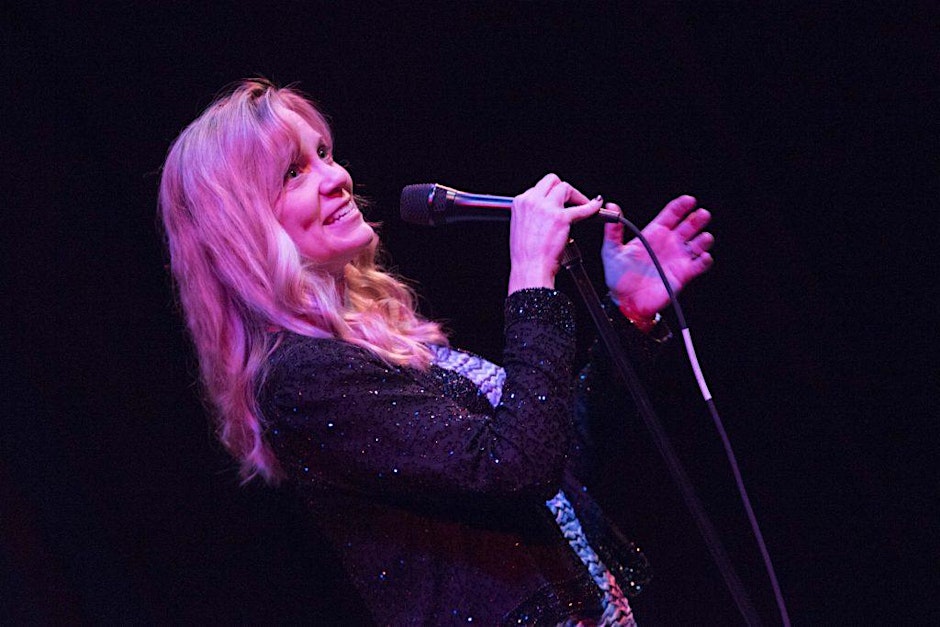 a woman singing into a microphone