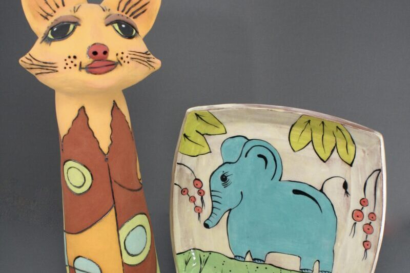 Colorful cat sculpture and elephant plate