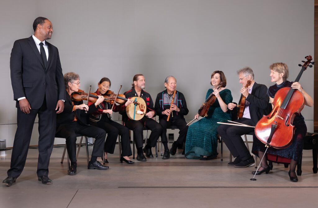 Musicians performing together in formal attire.