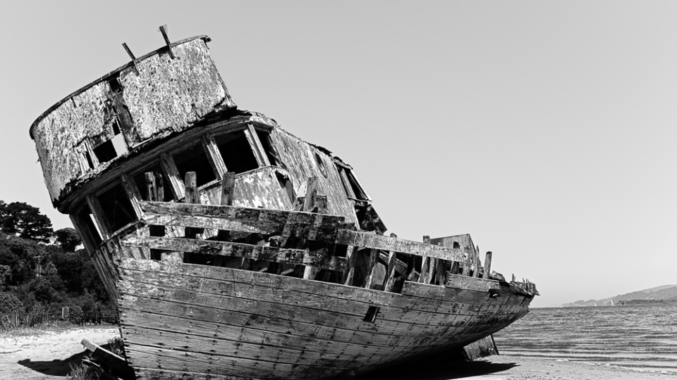 Abandoned shipwreck on sandy shore