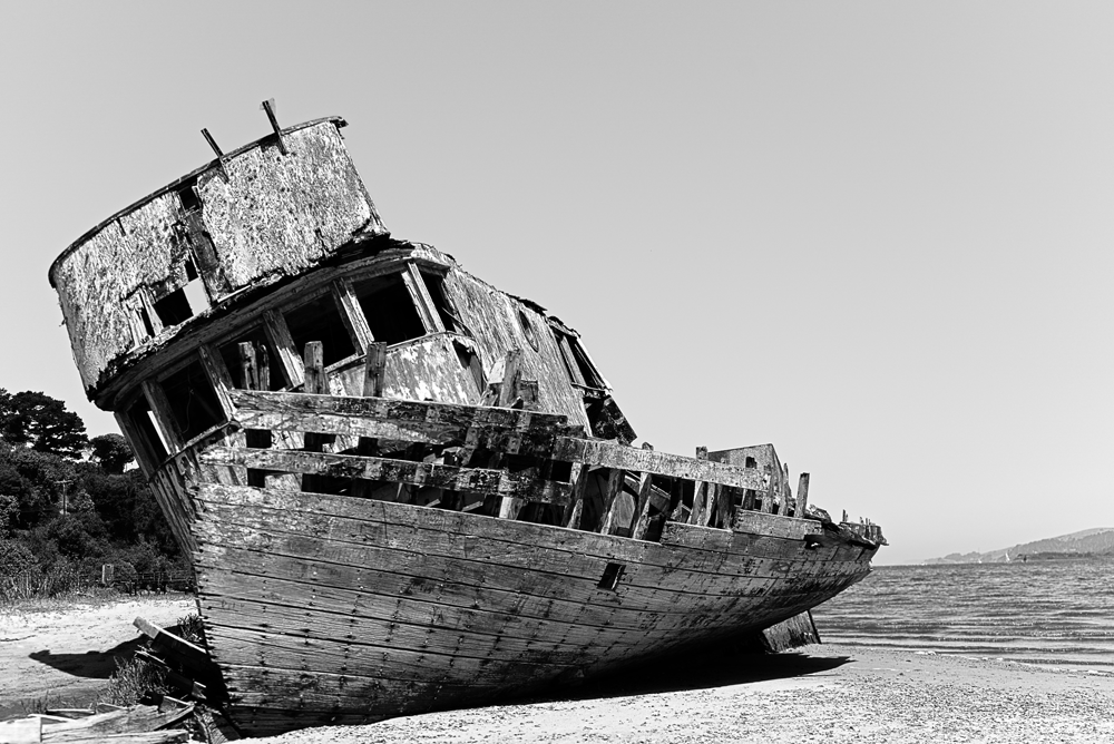 Abandoned shipwreck on sandy shore