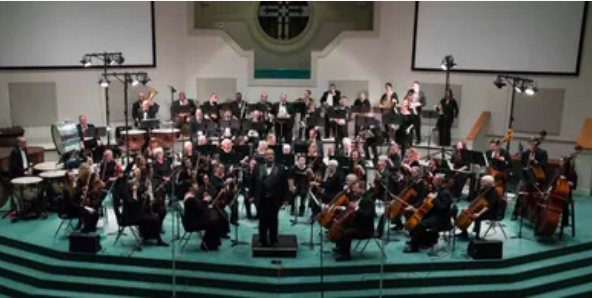 Large orchestra performing on stage