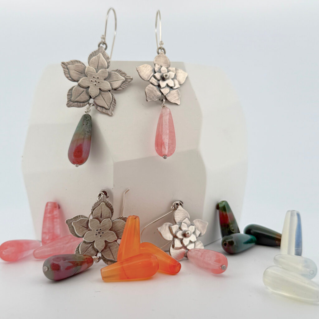 Silver earrings with colorful stone accents.