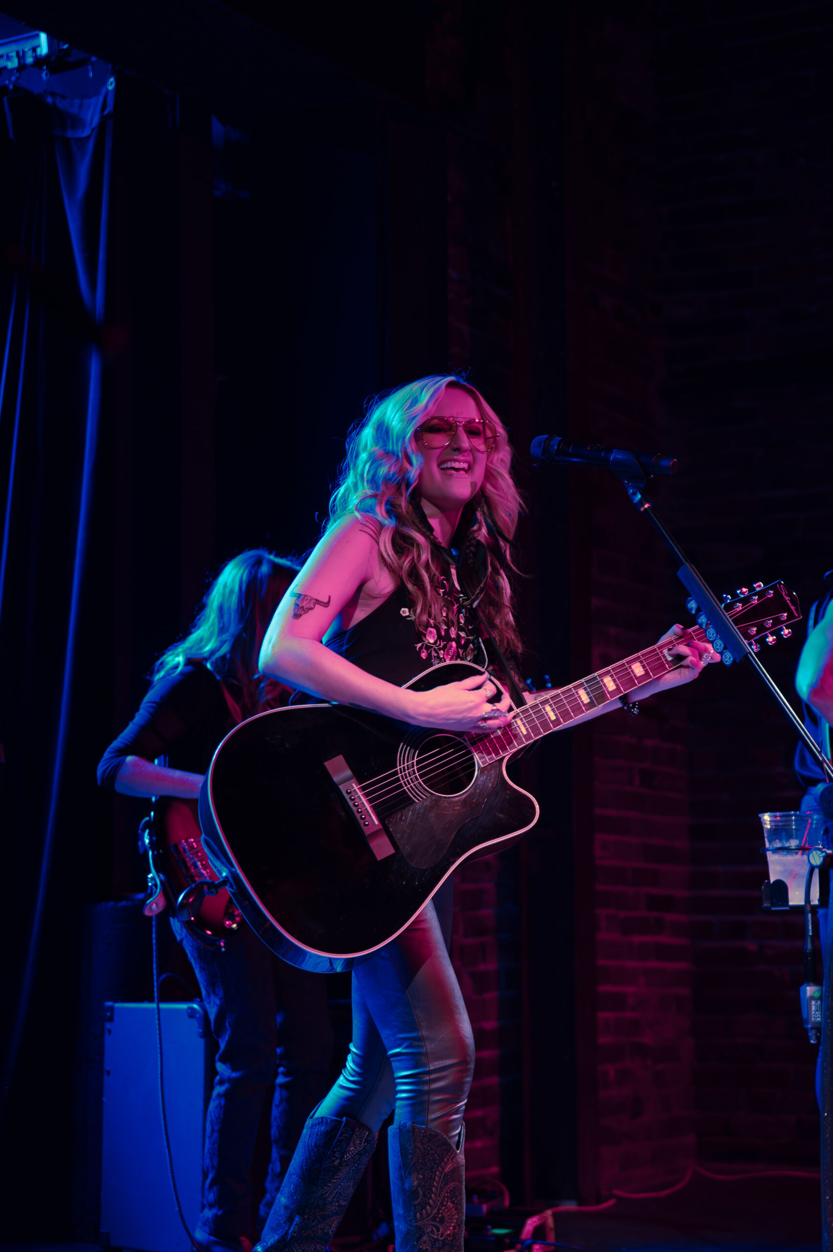 Woman playing guitar on stage