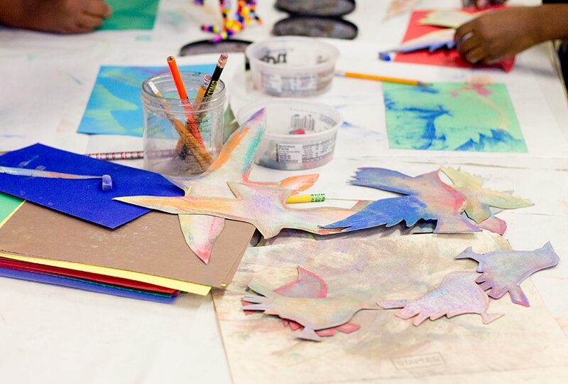 Colorful art supplies and bird cutouts