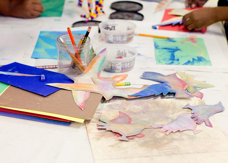 Colorful art supplies and bird cutouts