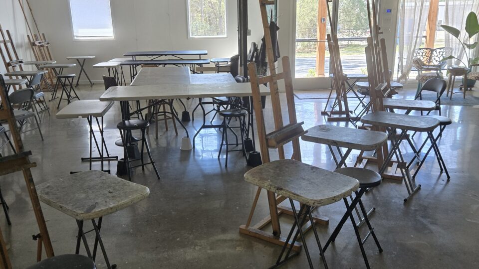 Empty art studio with easels and tables