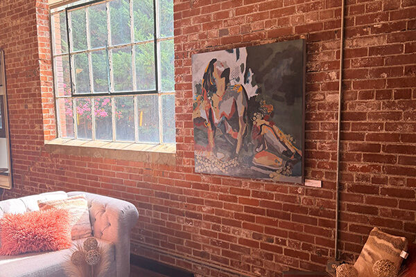 art hanging on a brick wall