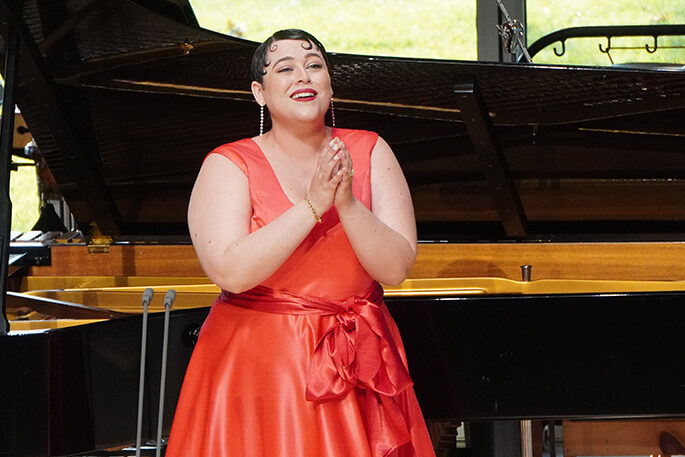 Woman singing in elegant red dress