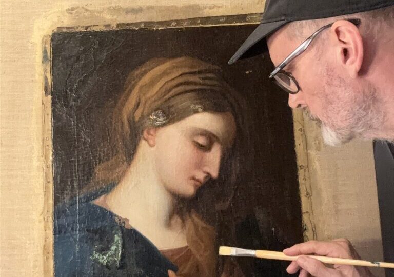 Man restoring a classical painting