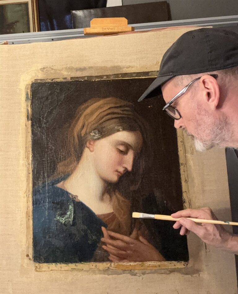 Man restoring a classical painting