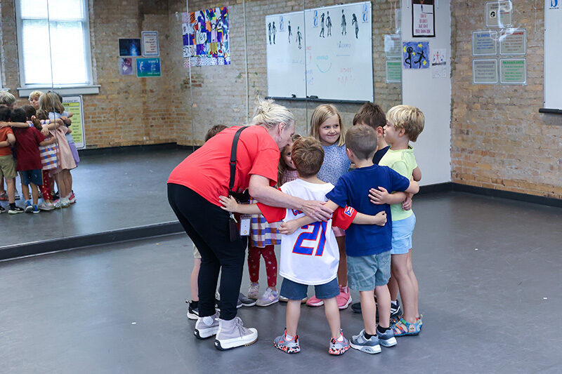Children huddled together with adult