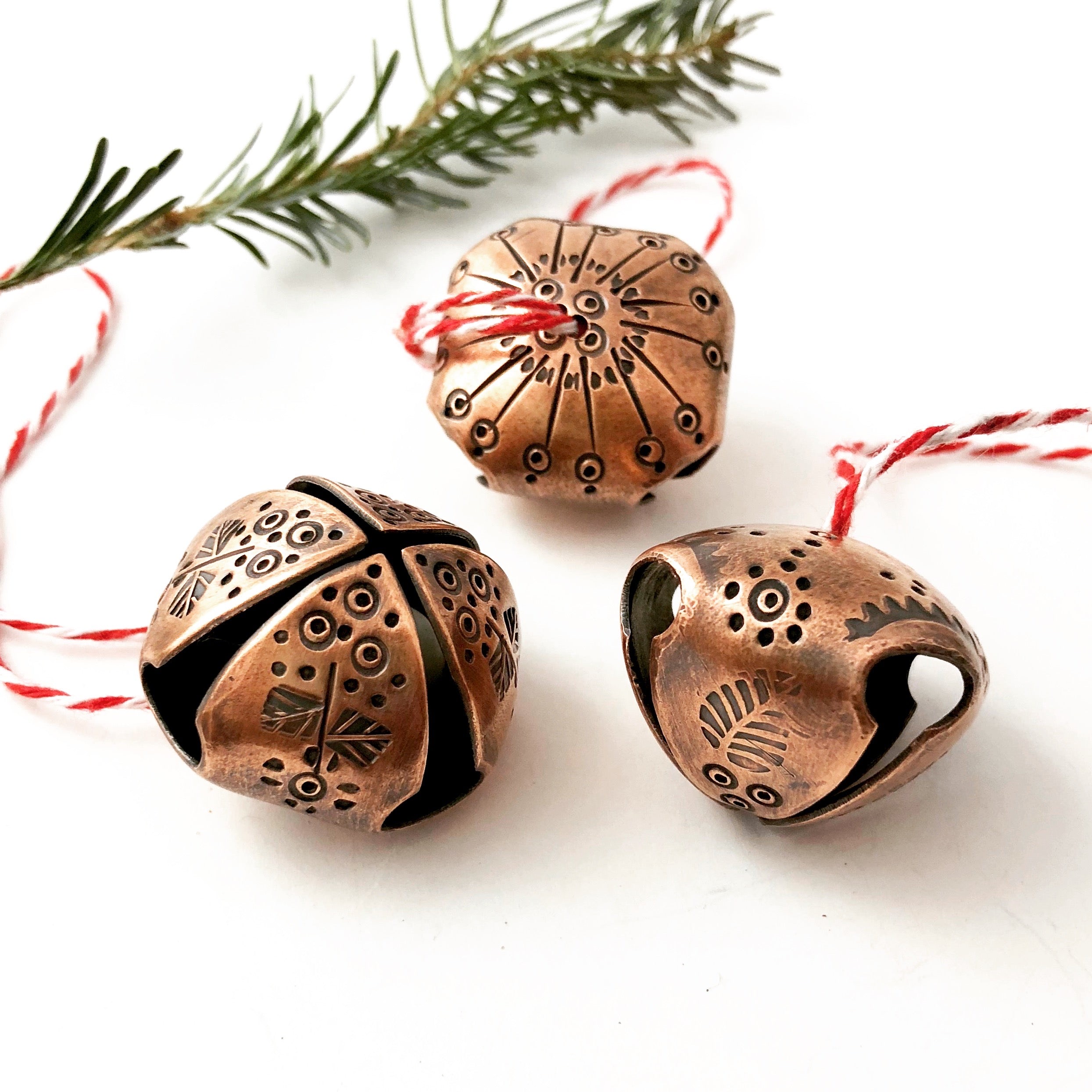 Three decorative copper jingle bells