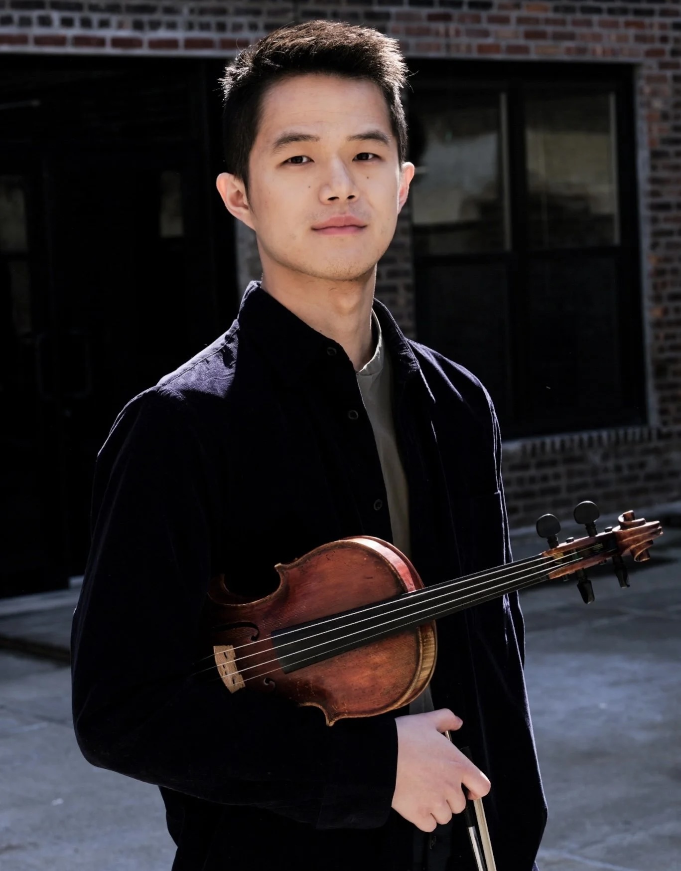 Young man holding a violin.
