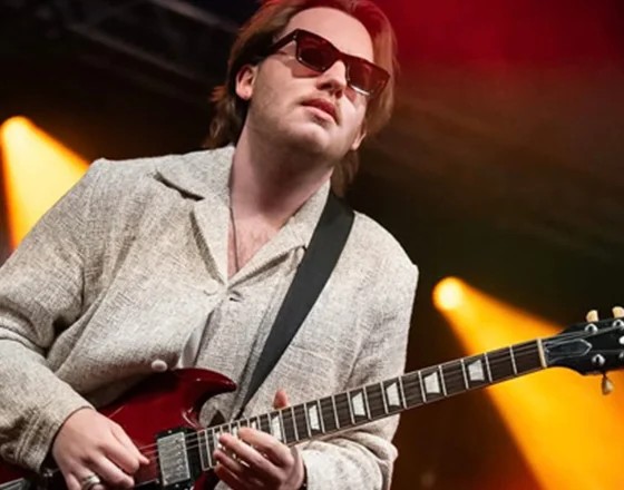 Musician playing guitar on stage