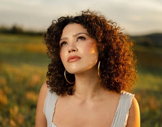 Woman with curly hair outdoors