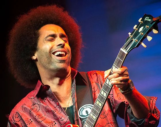 Musician playing guitar with enthusiasm