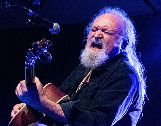 Musician passionately playing guitar onstage