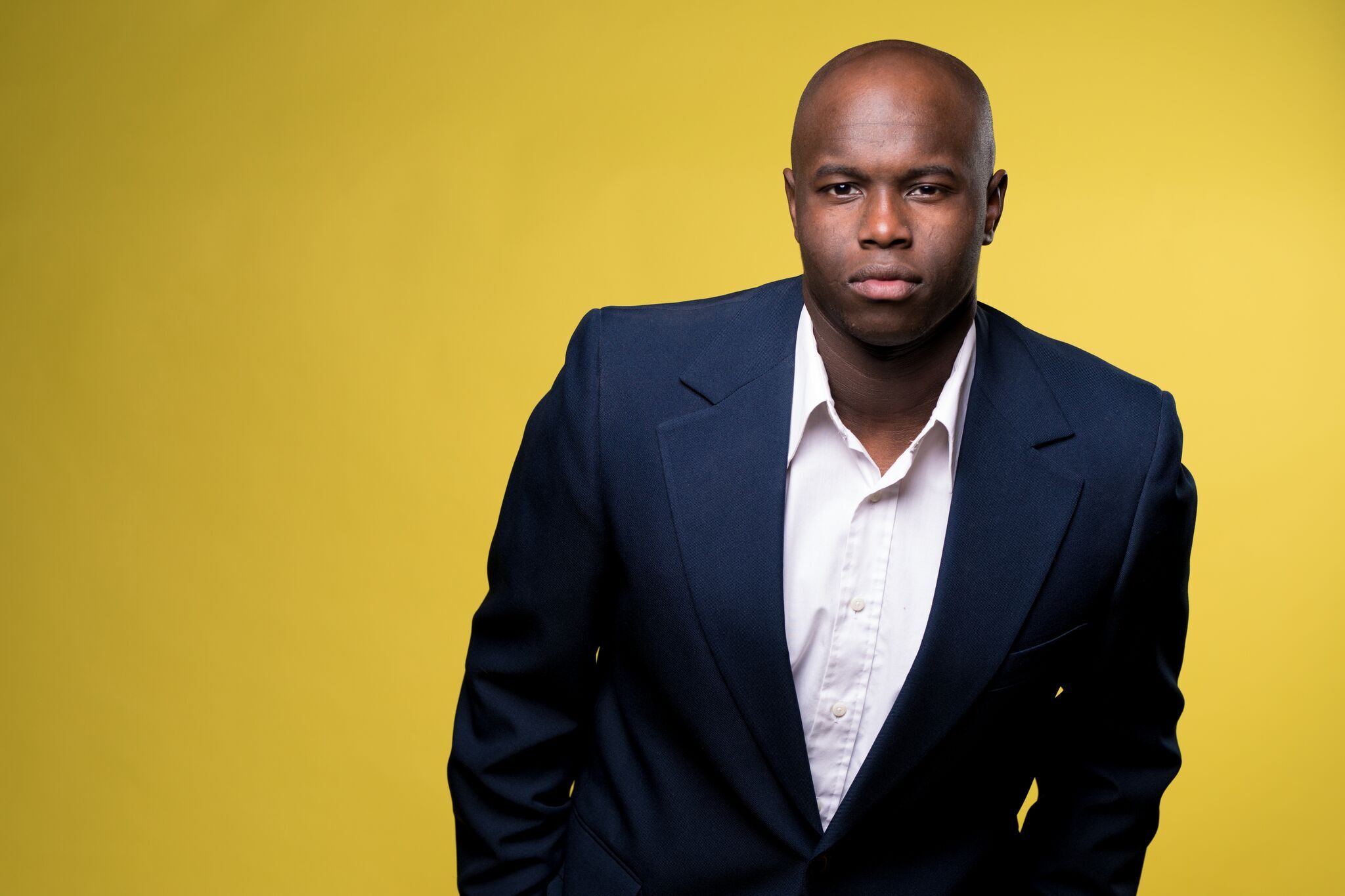 Man in suit against yellow background