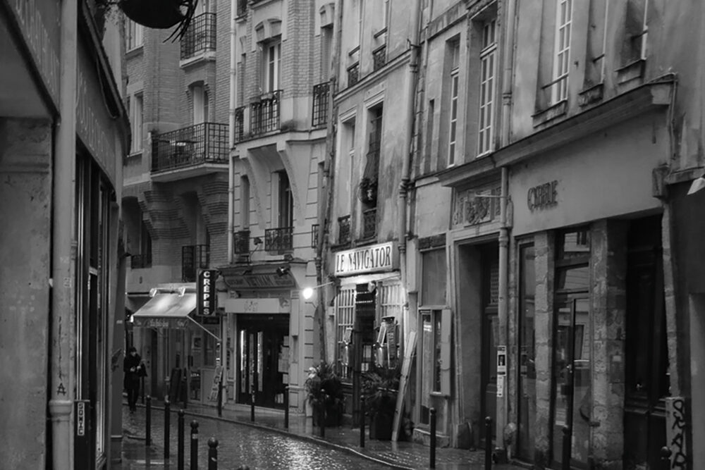 Quiet, rainy cobblestone street scene