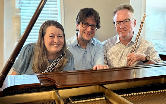 Musicians posing by a piano.