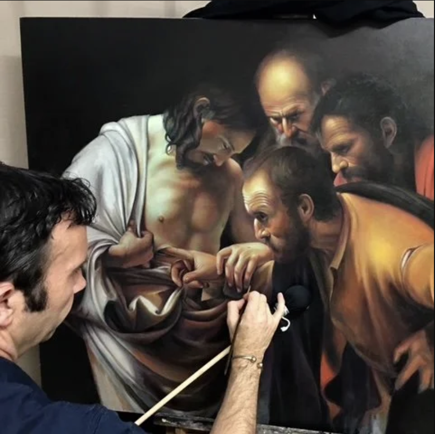 Artist painting a religious scene.
