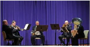 Brass musicians performing on stage.