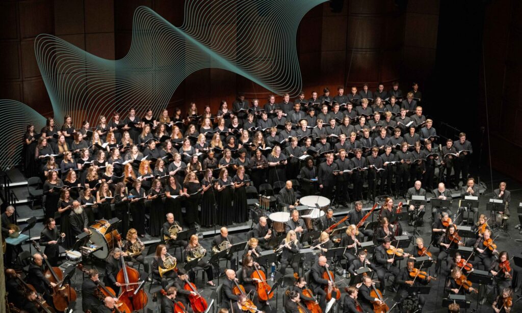 Large choir performing with orchestra