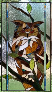 a stained glass window with an owl