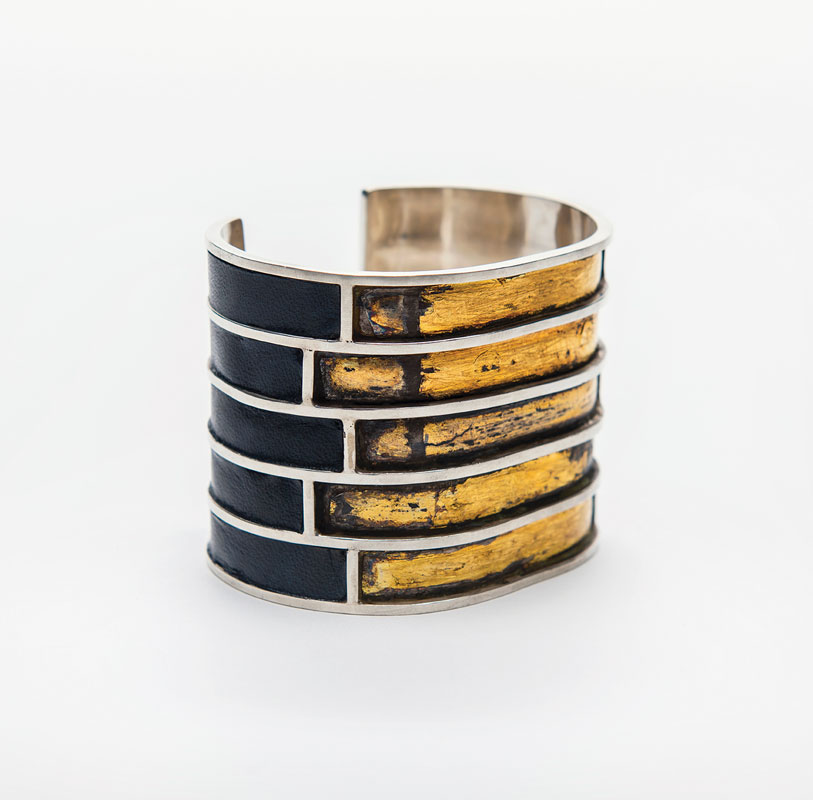 a bracelet with gold and black stripes
