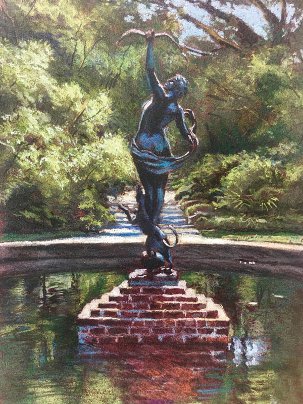 a statue of a woman in a pond