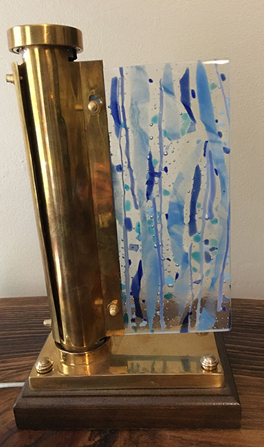 Fused glass panel in antique brass lamp 
7.5 x 4.5 x 12.5 inches 