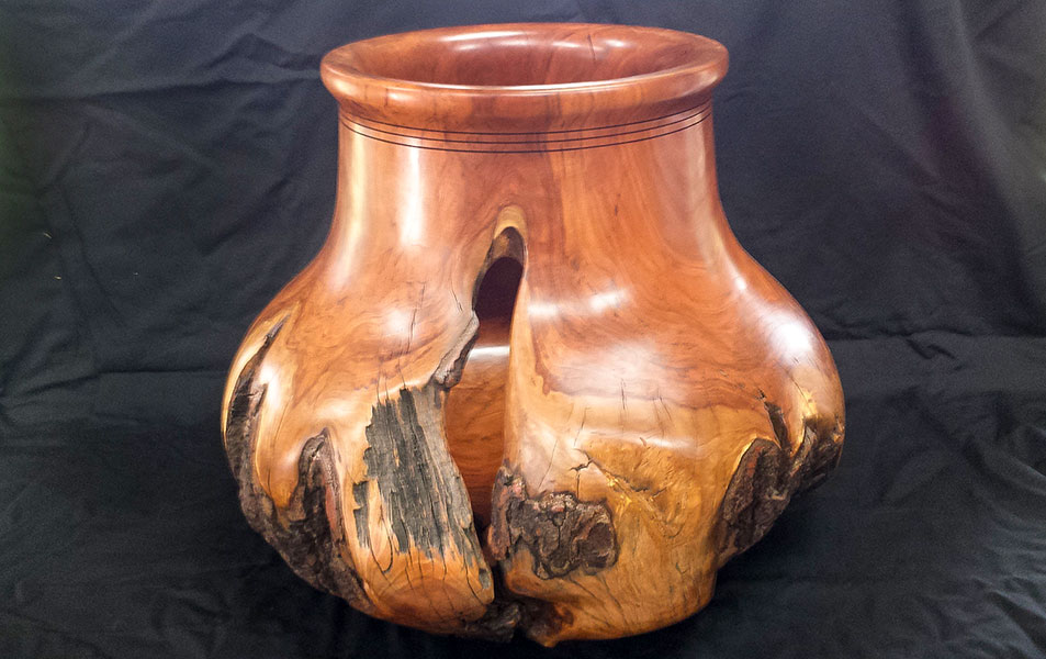 a wooden vase with a hole in it
