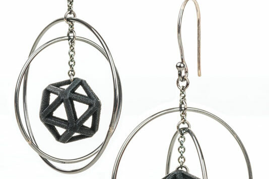 a pair of earrings with a black object