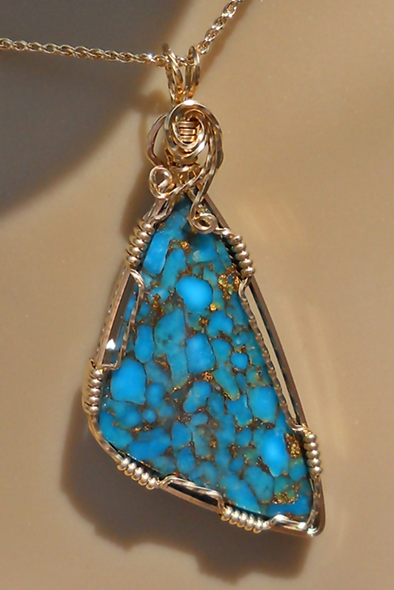 a blue stone in a gold wire