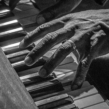 a hand on a piano